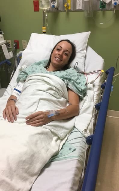 Photo of a woman in a hospital bed in a Grand Cayman hospital.