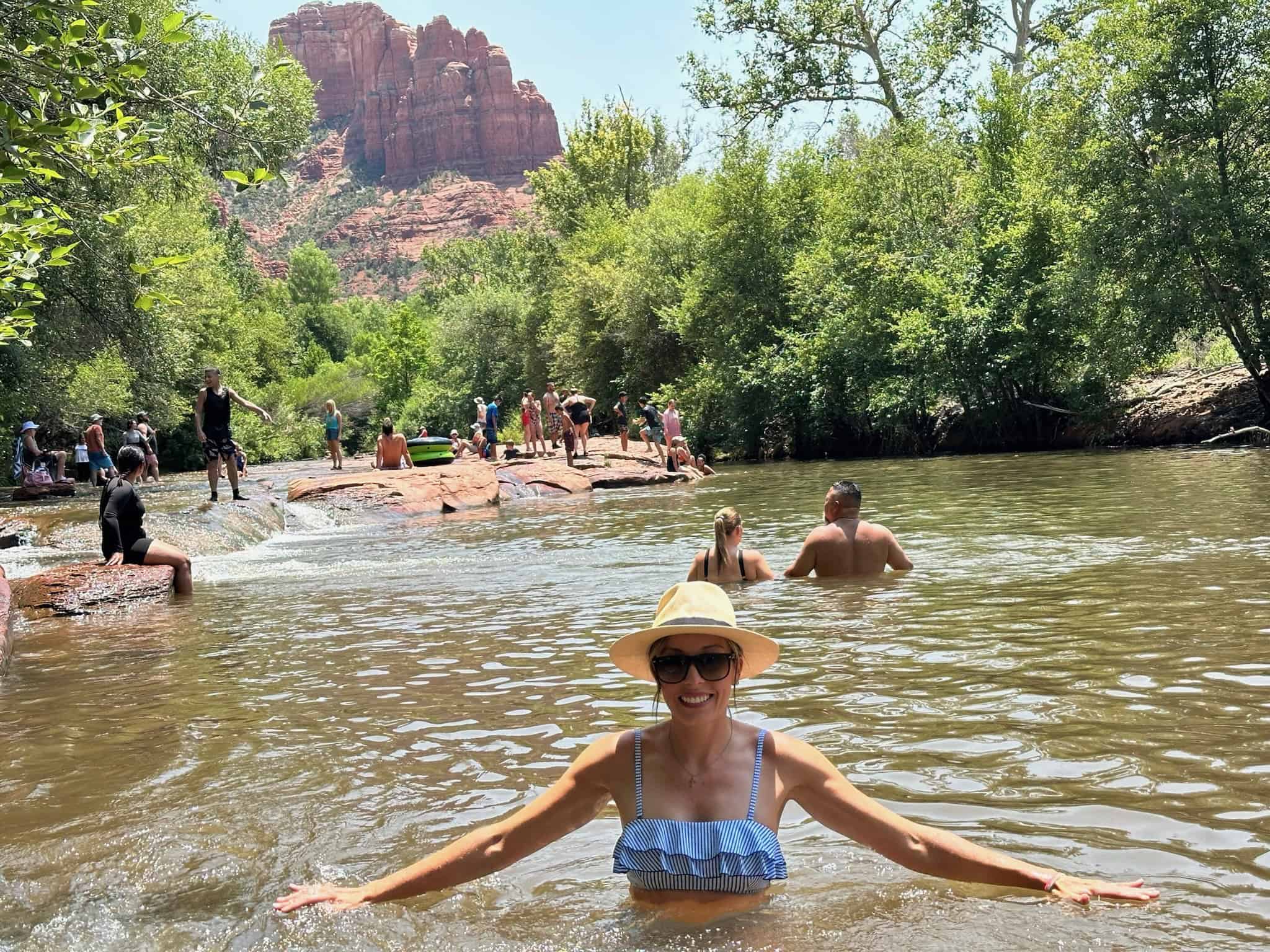 People swimming and cliff jumping at Crescent Moon Picnic Site when it's hot in Sedona.