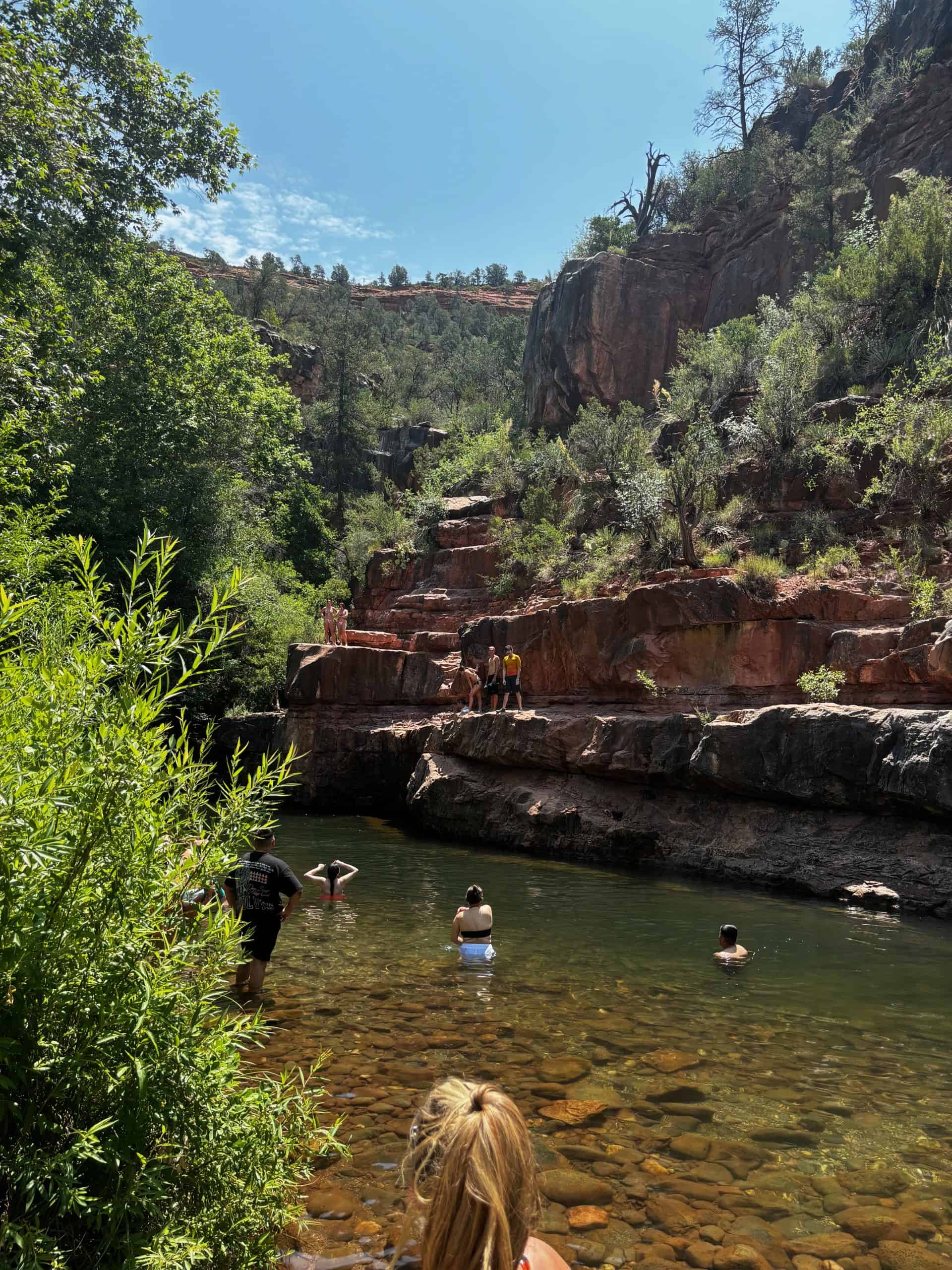 People swimming and cliff jumping at Grasshopper Point when it's hot in Sedona