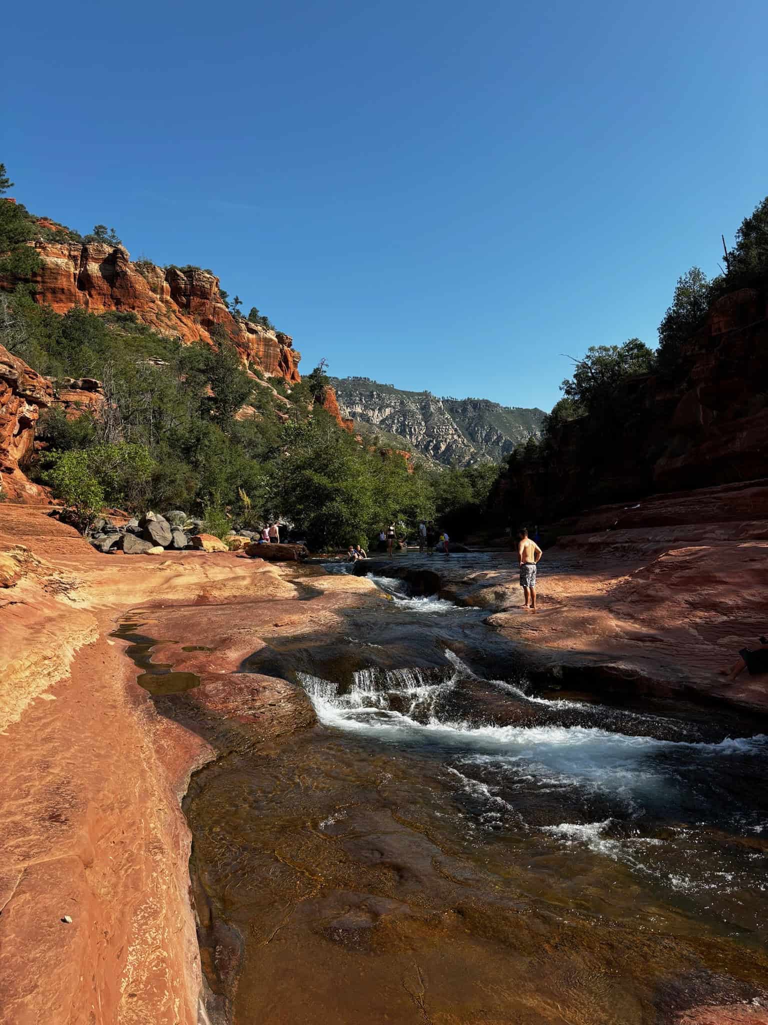 People swimming at Slide Rock when it's hot in Sedona.