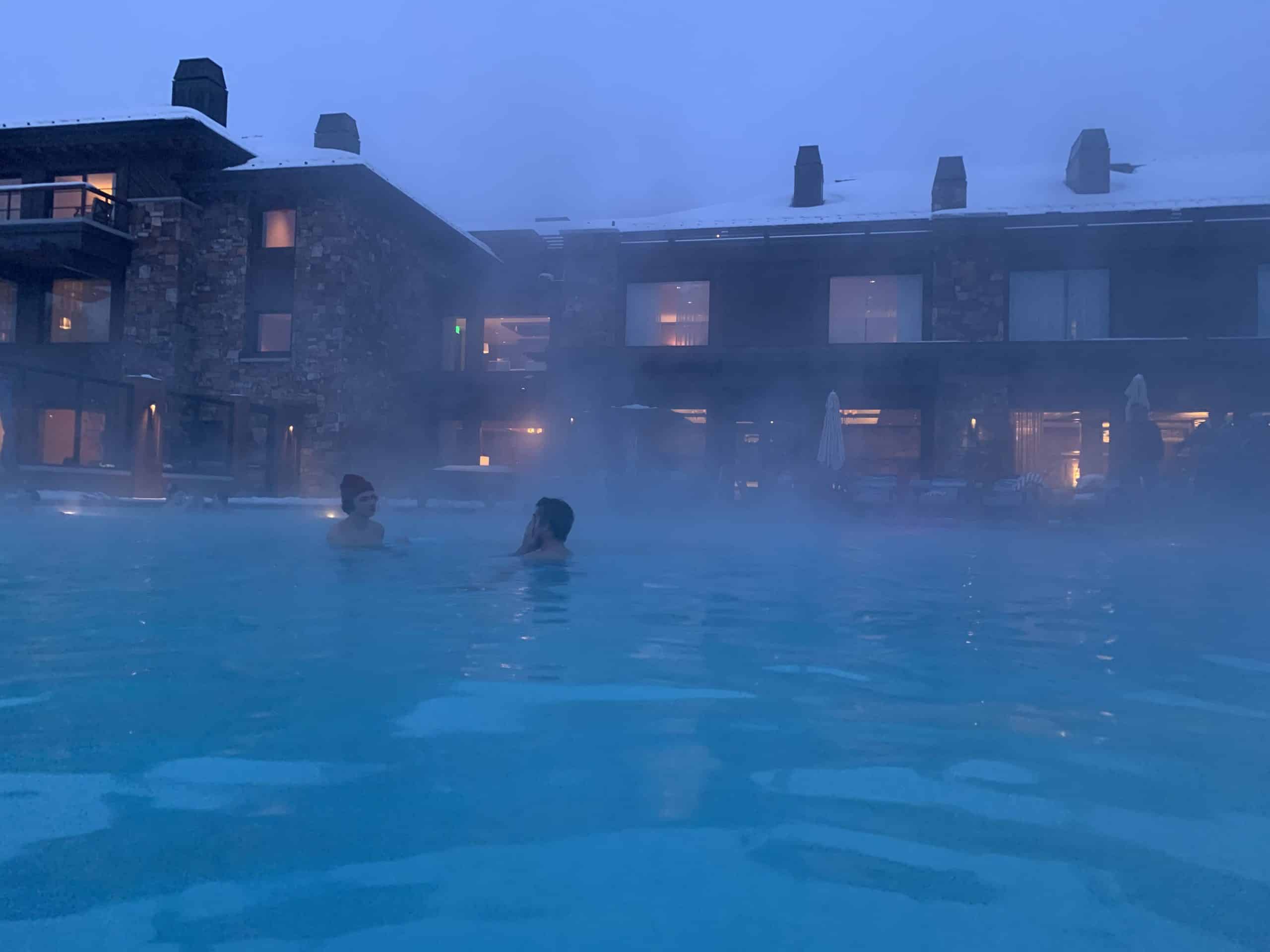 A heated pool at a mountain town resort in the winter