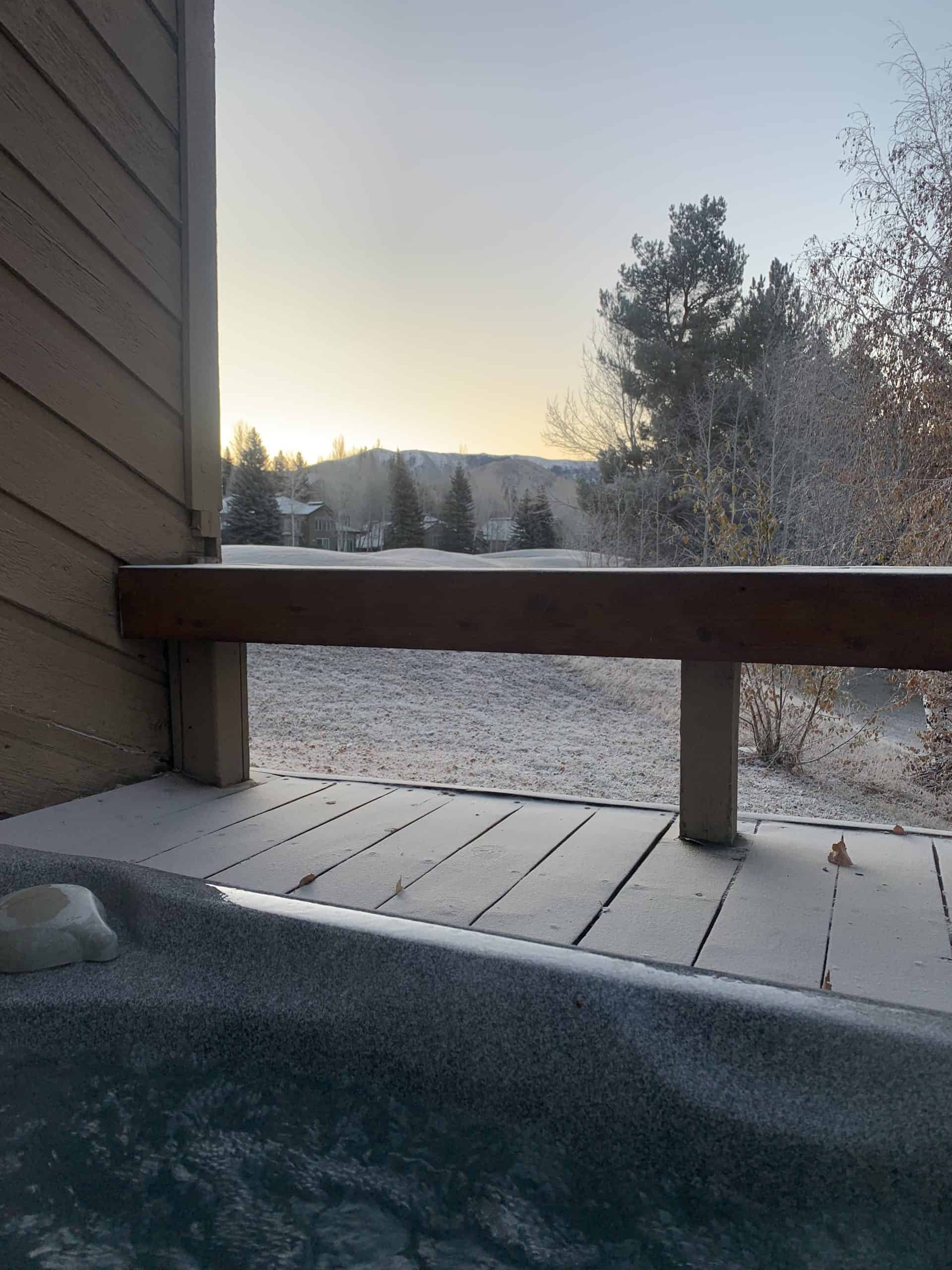 A view of a frosty golf course from a hot tub