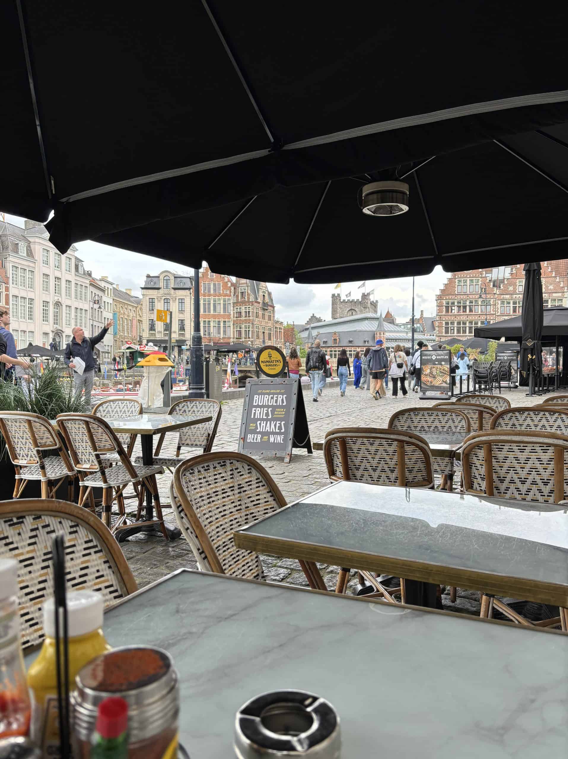 A view of the streets of Ghent, Belgium from a restaurant table along a canal. 
