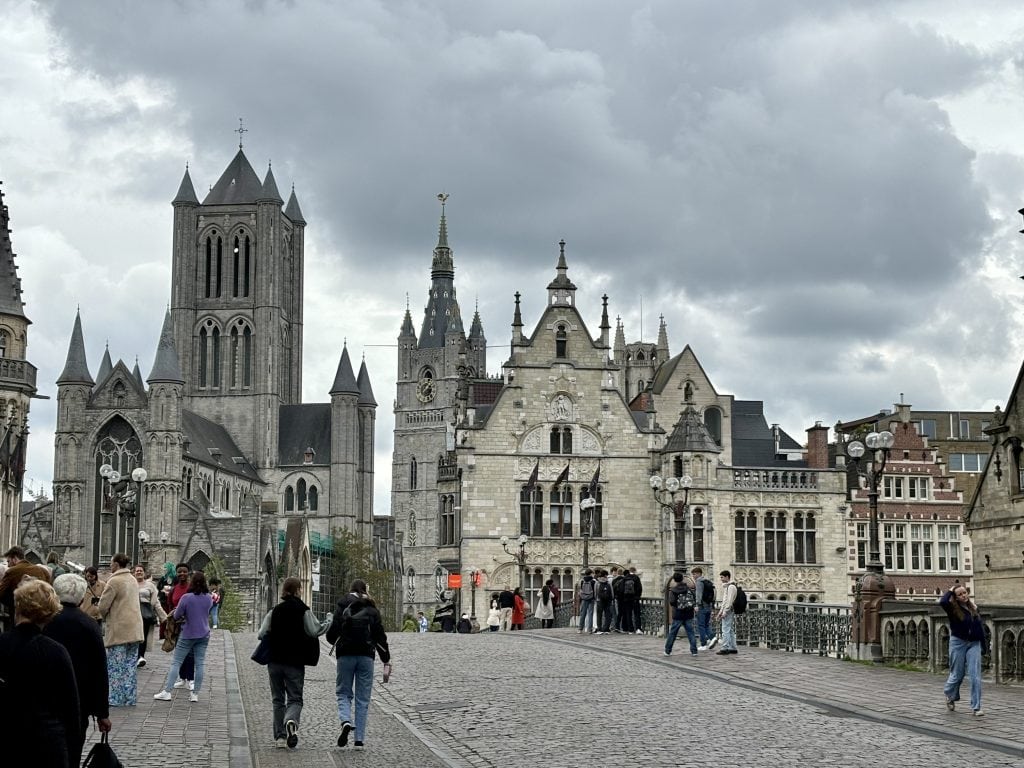 a bridge over a canal in Ghent, with a church on the other side.