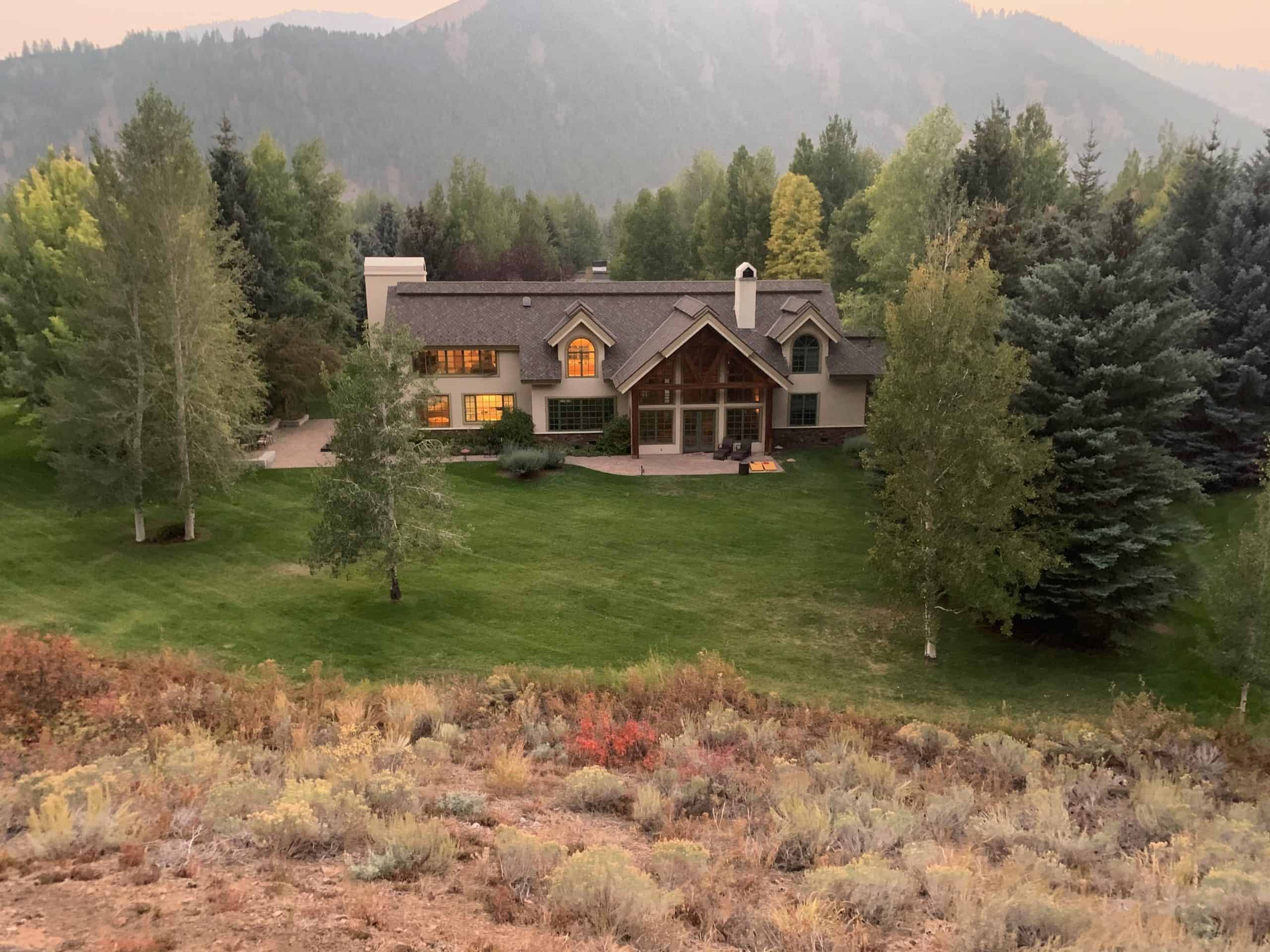 A home with mountains in the background.